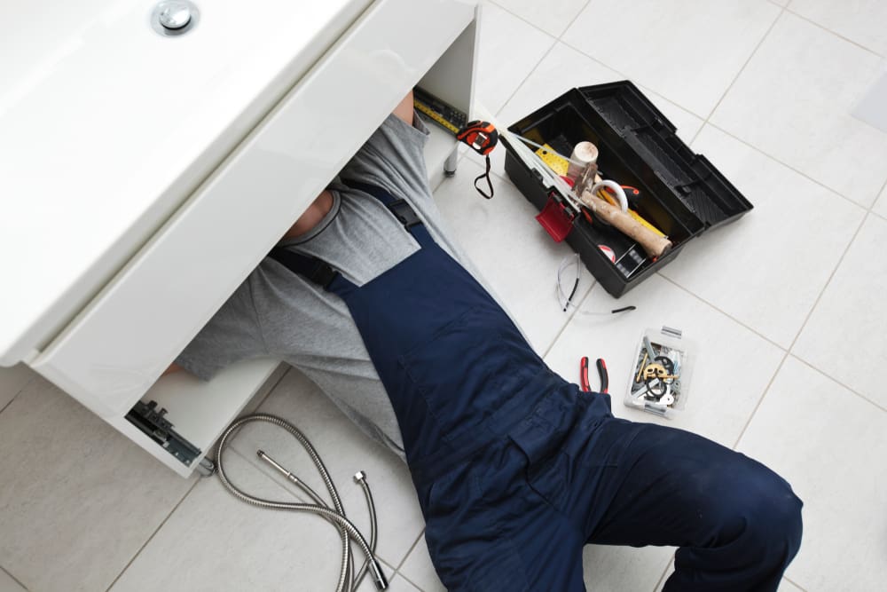 The,Young,Repairer,Is,Fixing,Sink,In,The,Bathroom